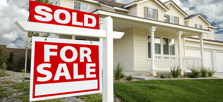 Modern two story single family home with a SOLD 'For Sale' sign in the front yard